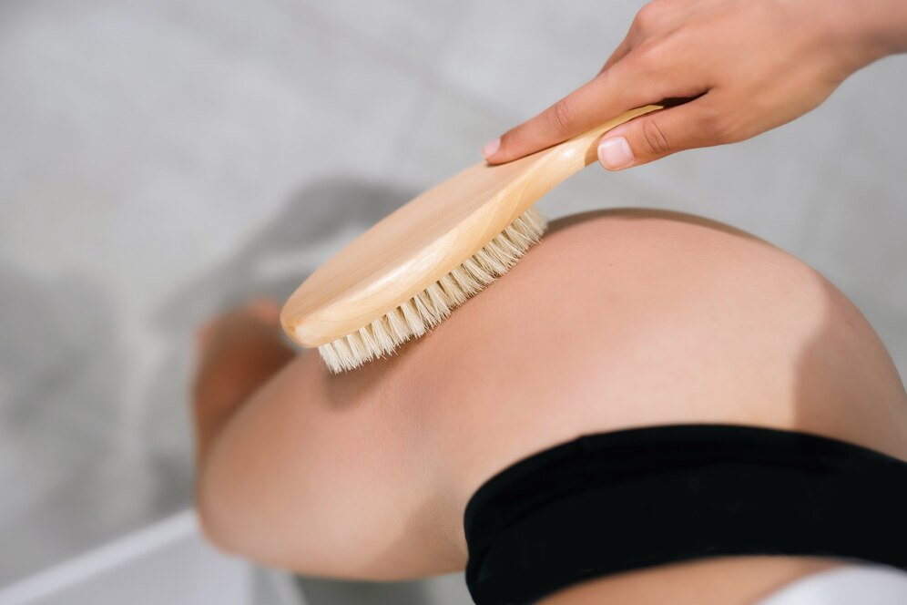 girl-stroking-her-leg-with-brush-bathroom-close-up_1153-6696.jpg