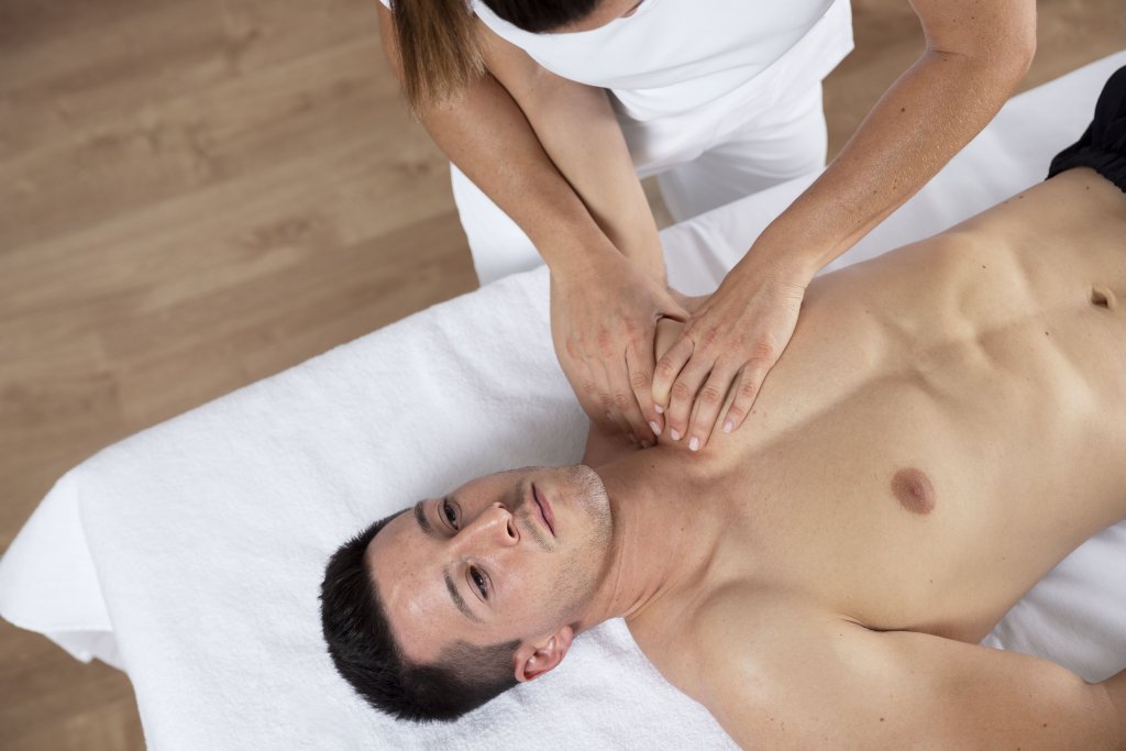 physiotherapist-performing-therapeutic-massage-on-male-client.jpg